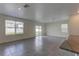 Bright, open living area with neutral tile floors and natural light from sliding glass door at 2855 Maiden Grass Isle, Wesley Chapel, FL 33543