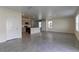 Open-concept living room with tile flooring connects seamlessly to the modern kitchen with island at 2855 Maiden Grass Isle, Wesley Chapel, FL 33543