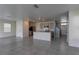 Open-concept living space featuring sleek tile floors, kitchen, and lots of natural light at 2855 Maiden Grass Isle, Wesley Chapel, FL 33543