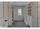 Walk-in closet with built-in shelving and ample storage space at 2855 Maiden Grass Isle, Wesley Chapel, FL 33543