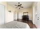 Bedroom with hardwood floors, ceiling fan and dresser at 407 Hawk Talon Dr, Lithia, FL 33547