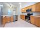 Bright kitchen with stainless steel appliances and light wood cabinets at 2634 Brookville Dr, Valrico, FL 33596
