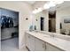 Double vanity bathroom with granite countertop and large mirror at 718 Chipper Dr, Sun City Center, FL 33573