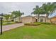 Single-story home with landscaped yard and driveway at 1519 Emerald Dunes Dr, Sun City Center, FL 33573