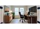 Modern home office features a large desk and plenty of natural light at 3659 Tea Leaf Aly, Land O Lakes, FL 34638
