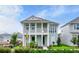 Two-story home with light blue exterior and a front porch at 3659 Tea Leaf Aly, Land O Lakes, FL 34638