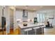 Modern kitchen with white cabinets, center island, and breakfast nook at 3659 Tea Leaf Aly, Land O Lakes, FL 34638