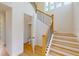 Elegant staircase with wood railings and a half bath underneath at 3659 Tea Leaf Aly, Land O Lakes, FL 34638