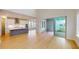 Open kitchen with island, stainless steel appliances, and access to patio at 3659 Tea Leaf Aly, Land O Lakes, FL 34638