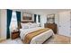 Main bedroom with wood furniture and teal curtains at 3659 Tea Leaf Aly, Land O Lakes, FL 34638