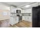 Modern kitchen with white cabinets and granite countertops at 206 E Frierson Ave, Tampa, FL 33603