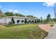 Side view of house showing the garage, landscaping, and driveway at 1215 S Keene Rd, Clearwater, FL 33756