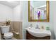Clean bathroom with sink, toilet and gold framed mirror at 1215 S Keene Rd, Clearwater, FL 33756