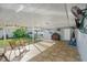 Covered patio with tiled floor and seating, overlooking backyard at 1215 S Keene Rd, Clearwater, FL 33756