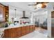 Open concept kitchen with granite island, stainless steel appliances, and wood cabinets at 1215 S Keene Rd, Clearwater, FL 33756