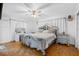 Spacious main bedroom with ornate bed, hardwood floors, and ample natural light at 1215 S Keene Rd, Clearwater, FL 33756