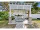 Relaxing outdoor kitchen with grill and seating under a pergola at 1215 S Keene Rd, Clearwater, FL 33756