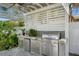 Outdoor kitchen with stainless steel appliances and a built-in grill at 1215 S Keene Rd, Clearwater, FL 33756