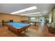 Spacious game room featuring a pool table and multiple tables perfect for entertainment and relaxation at 5390 Magnolia N Trl, Pinellas Park, FL 33782