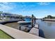 Private boat lift on a wooden dock, offering convenient water access at 406 Islebay Dr, Apollo Beach, FL 33572
