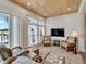 Relaxing sunroom with water views, comfortable wicker seating, and wood ceiling at 406 Islebay Dr, Apollo Beach, FL 33572