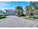 Charming house exterior with a gray-blue facade and lush landscaping at 406 Islebay Dr, Apollo Beach, FL 33572