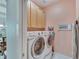 Laundry room with washer, dryer and ample storage at 406 Islebay Dr, Apollo Beach, FL 33572