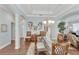 Elegant dining room boasts a glass-top table, wicker chairs, and decorative wall art at 406 Islebay Dr, Apollo Beach, FL 33572