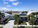 Aerial view of a charming house with a gray-blue exterior and palm trees at 406 Islebay Dr, Apollo Beach, FL 33572