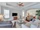 Bright living room with comfortable seating, hardwood floors, and a ceiling fan at 406 Islebay Dr, Apollo Beach, FL 33572