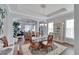 Spacious dining room features a glass-top table, wicker chairs, and a view into the living room at 406 Islebay Dr, Apollo Beach, FL 33572