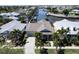 Aerial view of canal-front house with gray-blue exterior and palm trees at 406 Islebay Dr, Apollo Beach, FL 33572