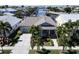 Aerial view showcasing a house with gray-blue exterior, driveway, and landscaping at 406 Islebay Dr, Apollo Beach, FL 33572