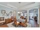 Bright dining room with glass table and wicker chairs, offering an open view to the living area at 406 Islebay Dr, Apollo Beach, FL 33572
