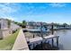 Private boat lift and dock with lush landscaping and canal views at 406 Islebay Dr, Apollo Beach, FL 33572