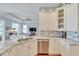 Spacious kitchen with granite countertops, stainless steel appliances, and white cabinets at 406 Islebay Dr, Apollo Beach, FL 33572
