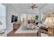 Open living room with hardwood floors, a large TV, and ample natural light at 406 Islebay Dr, Apollo Beach, FL 33572