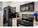 Modern kitchen with black appliances and light countertops at 4221 W Spruce St # 2205, Tampa, FL 33607