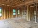 Spacious bedroom under construction with framed walls, windows, and floor underlayment at 4642 W Longfellow Ave, Tampa, FL 33629