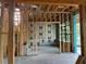 A framed room under construction with floor underlayment and wrapped insulation at 4642 W Longfellow Ave, Tampa, FL 33629