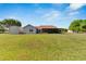 House exterior showcasing a screened patio and spacious backyard at 3526 Wiggins Meadows Ct, Plant City, FL 33566