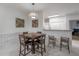 Dining area with a square table and four chairs, adjacent to kitchen at 4306 Bayside Village Dr # 204, Tampa, FL 33615