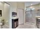 Bathroom showcasing a glass-enclosed shower, a vanity, and a cabinet with decorative accents at 582 8Th Nw St, Ruskin, FL 33570