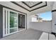 Balcony featuring black railings, geometric tile floor, recessed lighting, and sliding glass doors at 534 Estuary Shore Ln, Apollo Beach, FL 33572