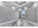 Bright bedroom features stylish gray walls, tray ceiling with fan and recessed lights, and a unique epoxy floor at 534 Estuary Shore Ln, Apollo Beach, FL 33572