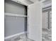 Walk-in closet with white wire shelving and epoxy floor, and lighting trim at 534 Estuary Shore Ln, Apollo Beach, FL 33572