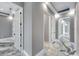 Bright hallway with gray walls, white trim, white doors, recessed lighting and epoxy floors at 534 Estuary Shore Ln, Apollo Beach, FL 33572