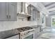 Gourmet kitchen featuring stainless steel appliances, custom cabinetry, and modern tile backsplash at 534 Estuary Shore Ln, Apollo Beach, FL 33572
