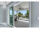 Lanai with a summer kitchen and glass railings overlooking a pool and backyard area at 534 Estuary Shore Ln, Apollo Beach, FL 33572