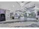 Open living area with marble floors, custom ceilings, modern kitchen, and granite staircase at 534 Estuary Shore Ln, Apollo Beach, FL 33572